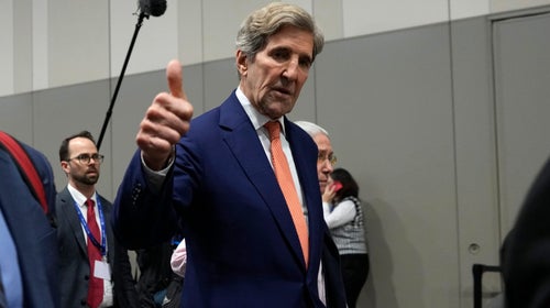 John Kerry flashes a thumbs up