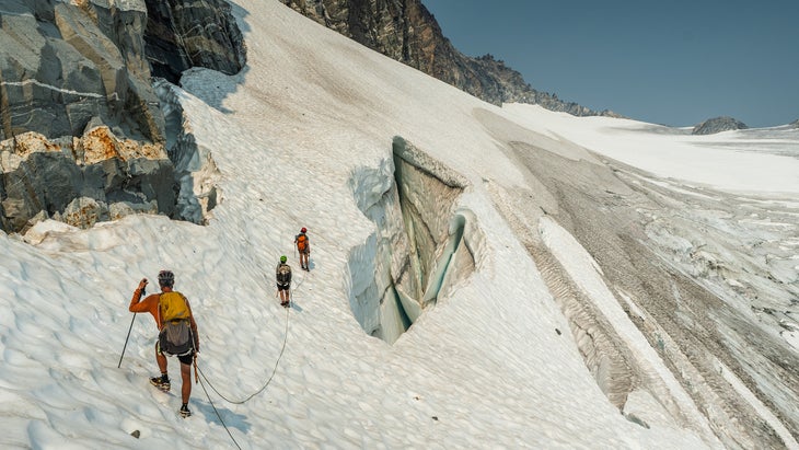 The trio scale a glacier. 