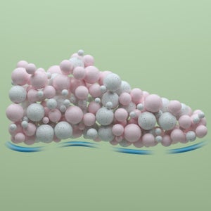 Digital generated image of a sport shoe made out of pink and white spheres against green background.