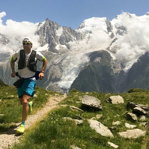 A runner runs on a high-altitude route in Chamonix, France.