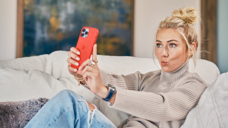 Mikaela Shiffrin taking a selfie on a couch