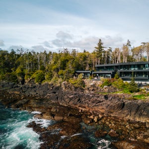 The exterior of The Nami Project, set between the rainforest and rocky coast