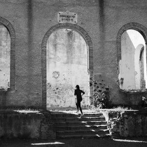 Woman running up the stairs at the ruins of Santa Brigida Hacienda