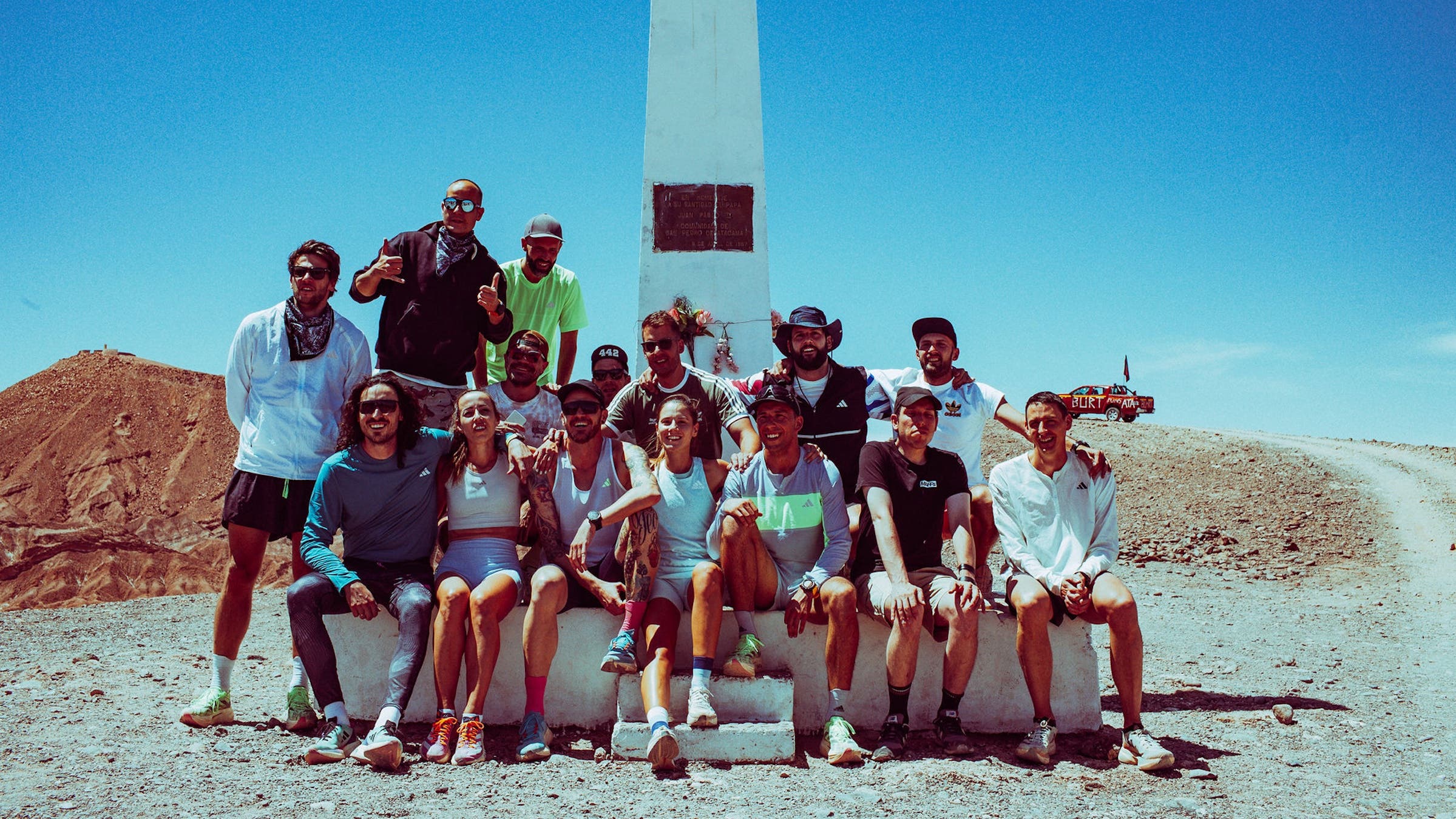 Runners celebrate at sunset after finishing the race in the desert
