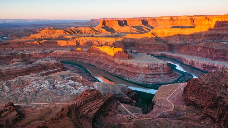 Sunrise at Dead Horse Point State Park, Utah, looking out over a hairpin in the Colorado River and to Canyonlands beyond