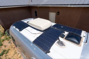 Airstream trailer with solar panels mounted to the roof. 