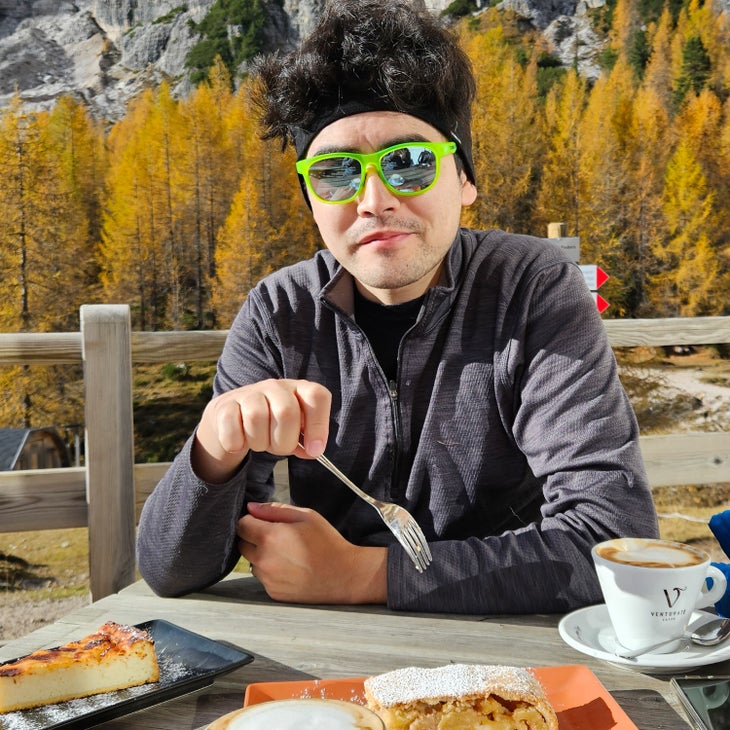 Topher Yanagihara on the patio at Rifugio Croda da Lago