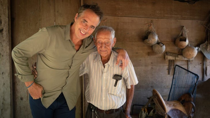 Blue Zones expert Dan Buettner with his arm around an elderly resident of a village in Costa Rica