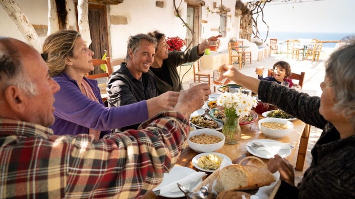 Dan Buettner sits down to a family lunch in Ikaria, Greece