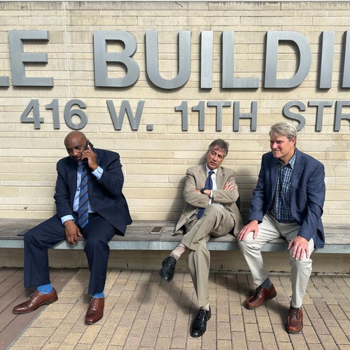 From left to right: prosecutors Ricky Jones and Guillermo Gonzalez sit with Eric Wilson.