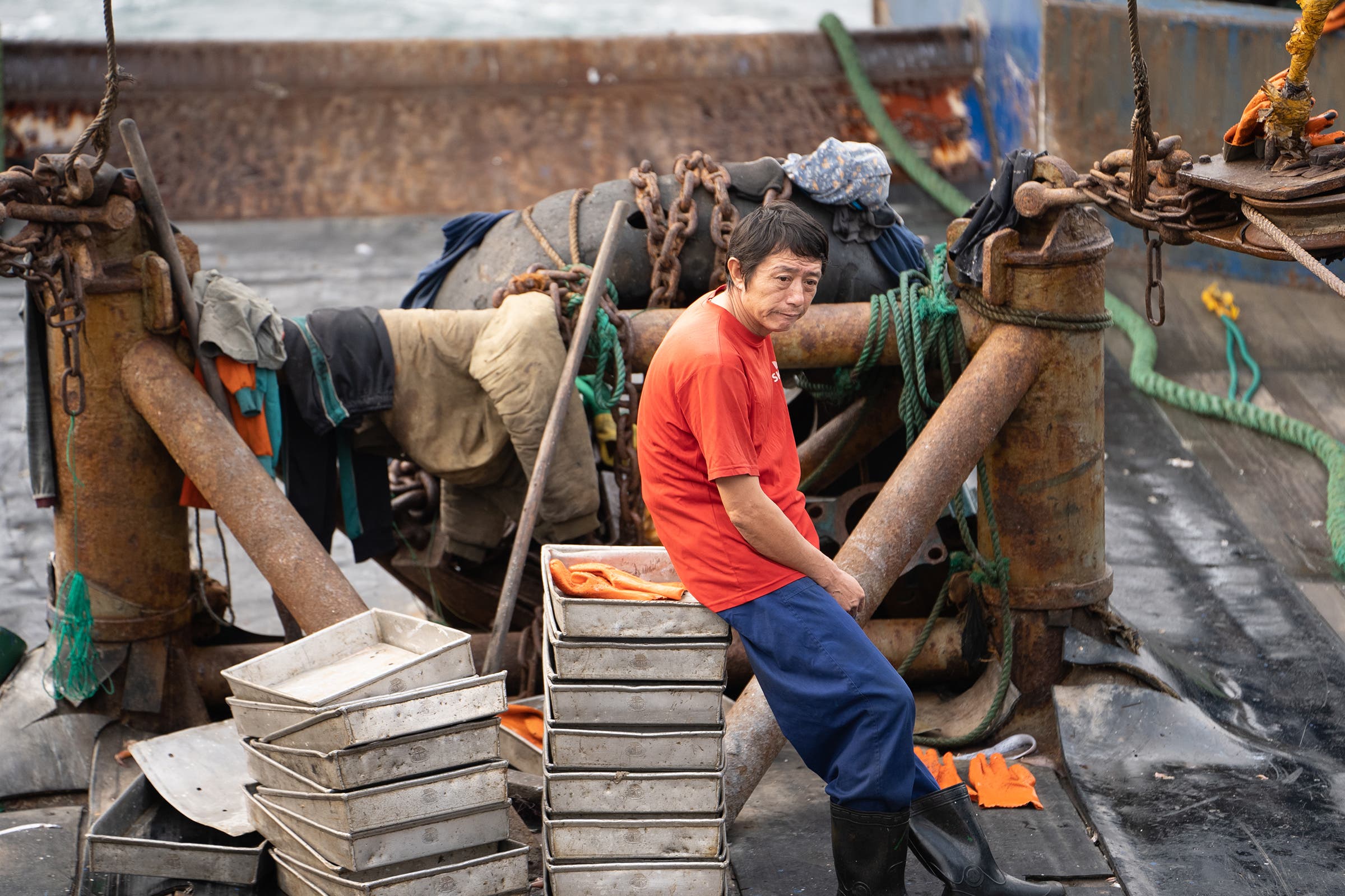 A fisherman sits taking a break