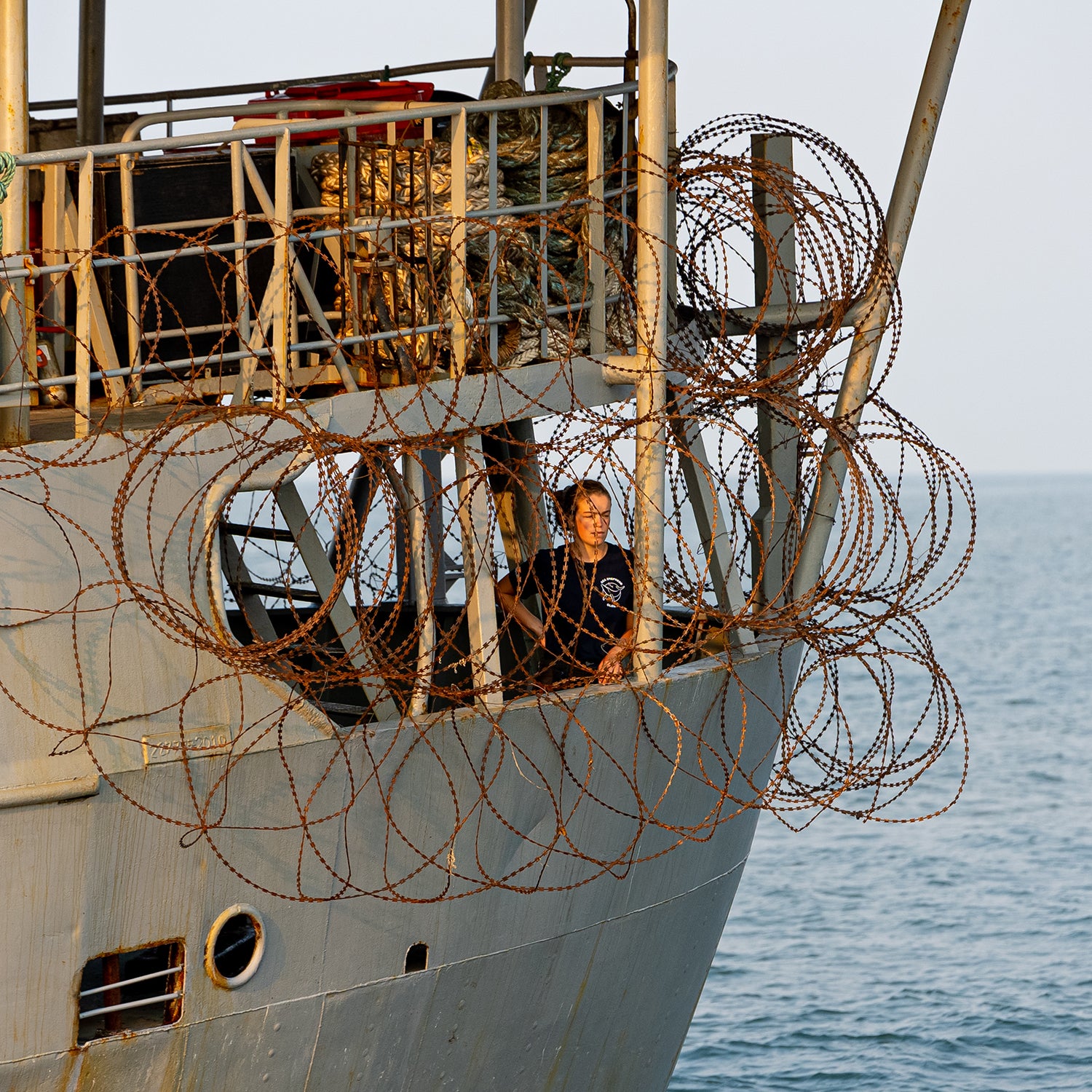 Brigitte looks out from the razor wire covered poop deck on the Bob Barker