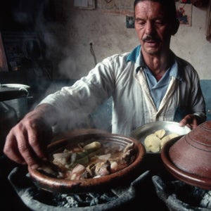A man prepares a Moroccan stew, tagine.