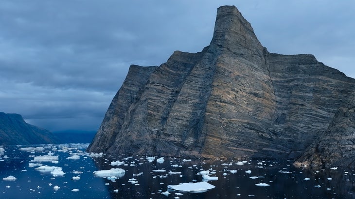 The massive big wall Ingmikortilaq rises from the sea in Greenland.