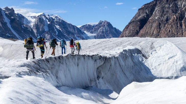 Adventurers cross a glacier in Greenland.