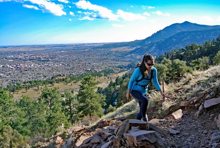 Woman hiking up mountain above Boulder, Colorado.