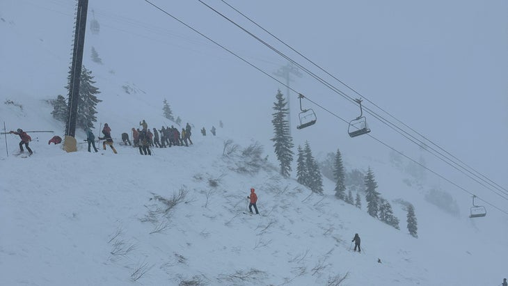 Rescuers search the debris field for survivors of an avalanche.