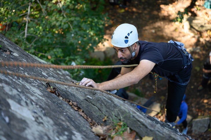 Vivek Puri climbing a slab outside