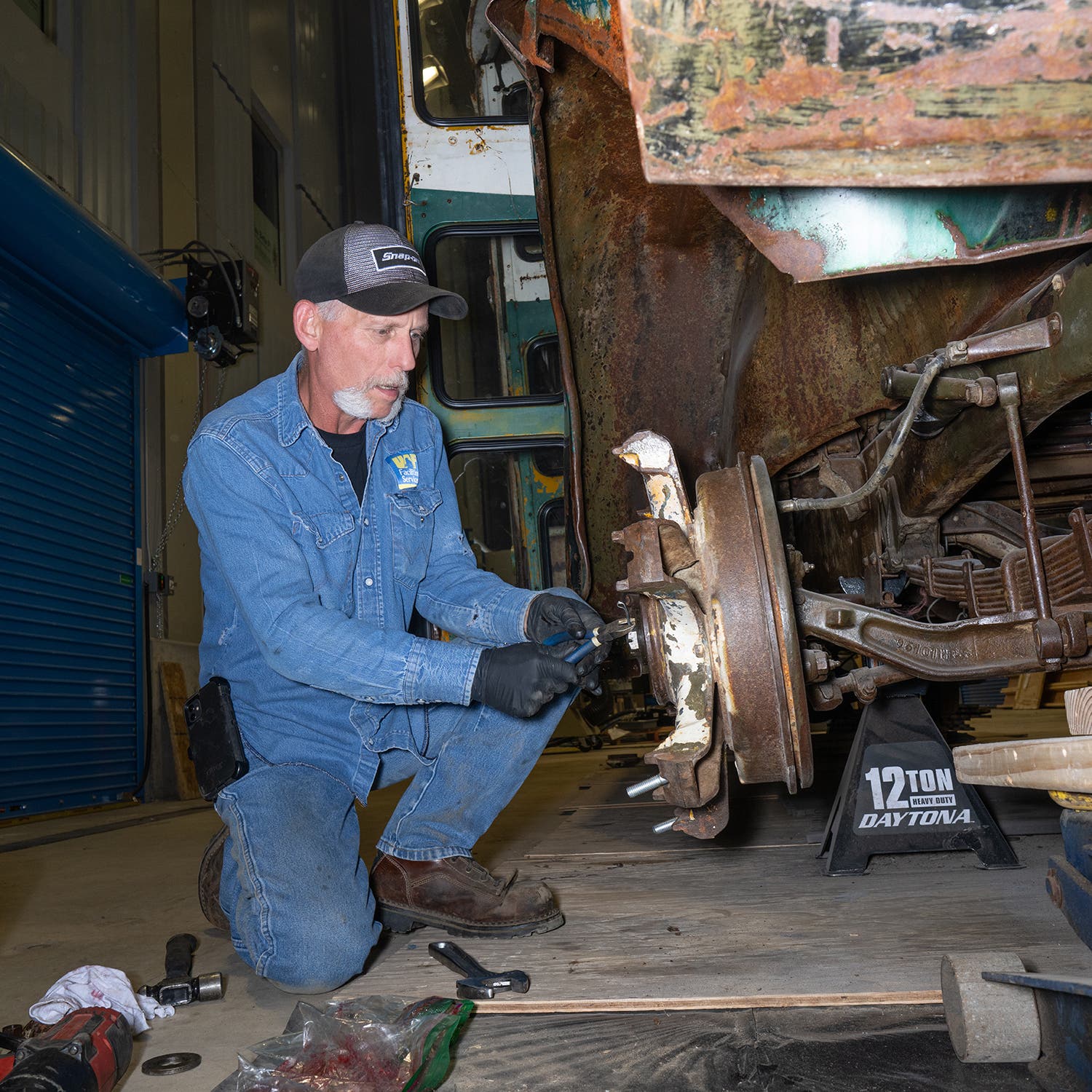 Terry Beasley, a maintenance shop technician with the University of Alaska Fairbanks, restoring the bus’s wheels