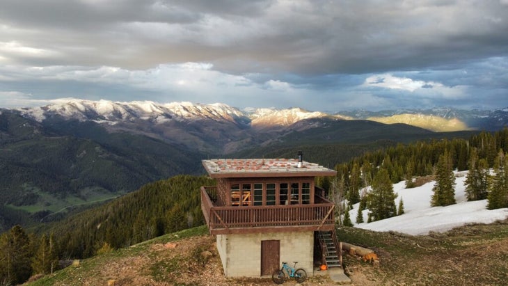A bike is perched against the base of the Garnet Mountain Fire Lookout, south of Bozeman, Montana.