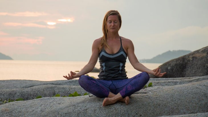 travel writer Jen Murphy doing yoga while on a trip to coastal Thailand