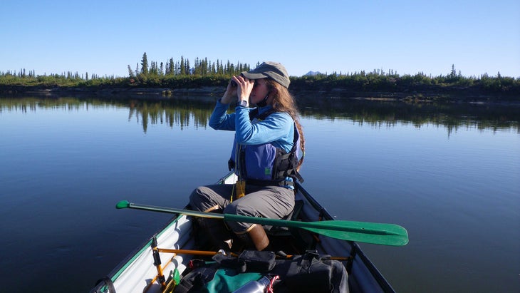 boater on the Kobuk River using binoculars for birdwatching