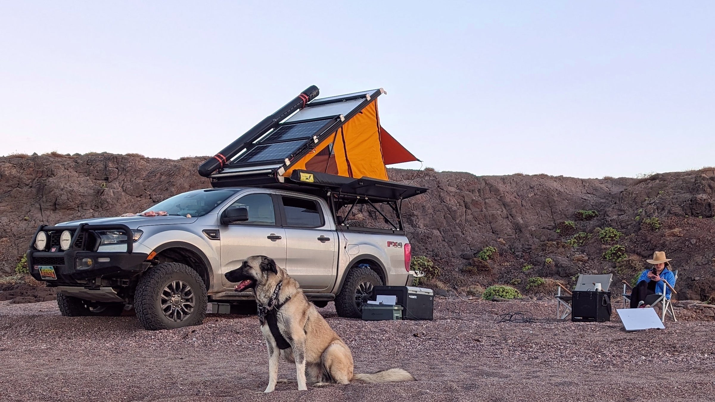 dog, truck, and rooftop tent in the backcountry