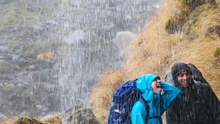 two hikers in rain wearing rainjackets with PFAS/forever chemicals