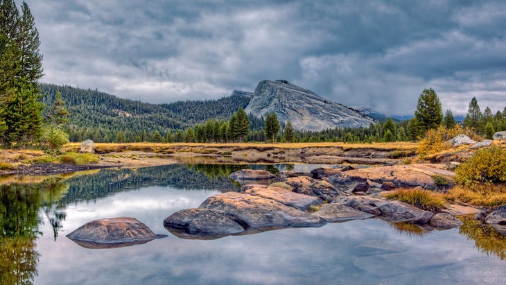 This image was shot in the Tuolumne Meadows area of Yosemite National Park. The river in the foreground is the Tuolumne River and Lembert Dome (9450') can be seen in the background.