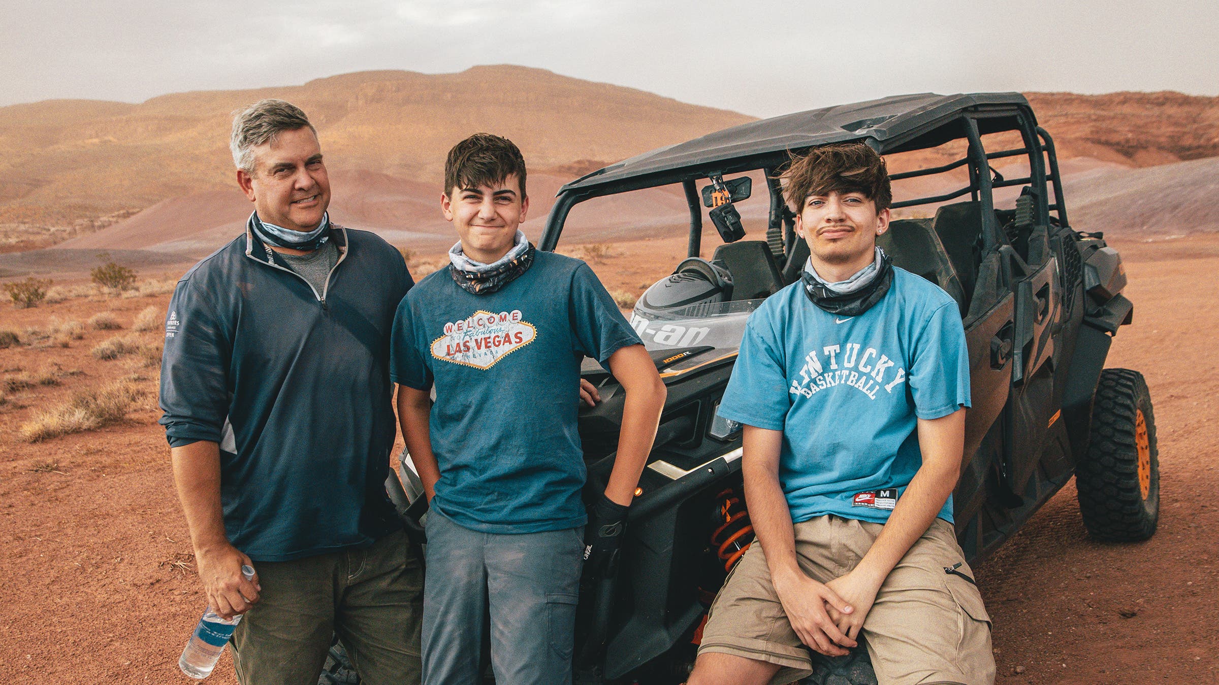 A father and two boys relax in front of their UTV in southern Utah.