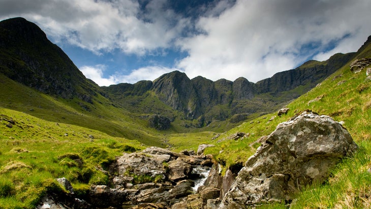 Knoydart scottish highlands with waterfall and green field