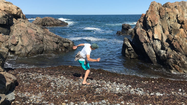 Man skipping stones off the coast of Maine
