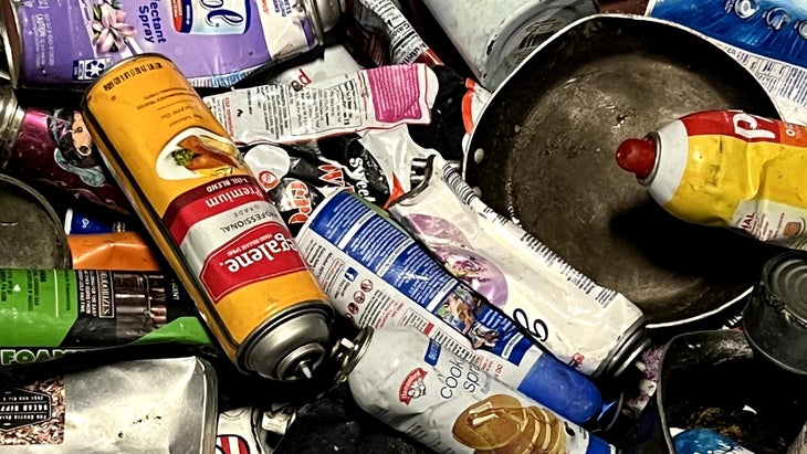 discarded aerosol cans and pots at materials recovery facility