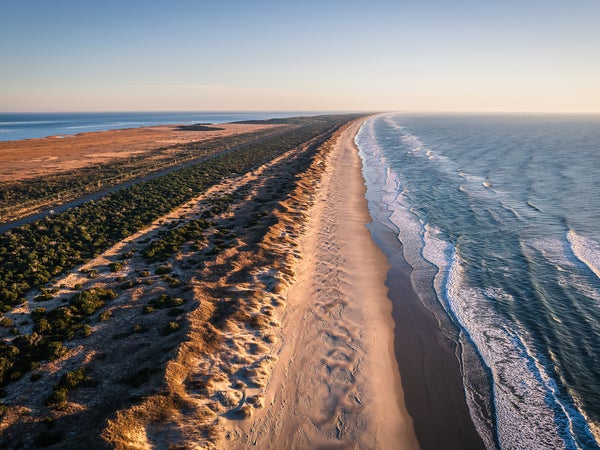 Aerial view of coastline and sand dunes of Ocracoke Island at sunrise, North Carolina, USA.