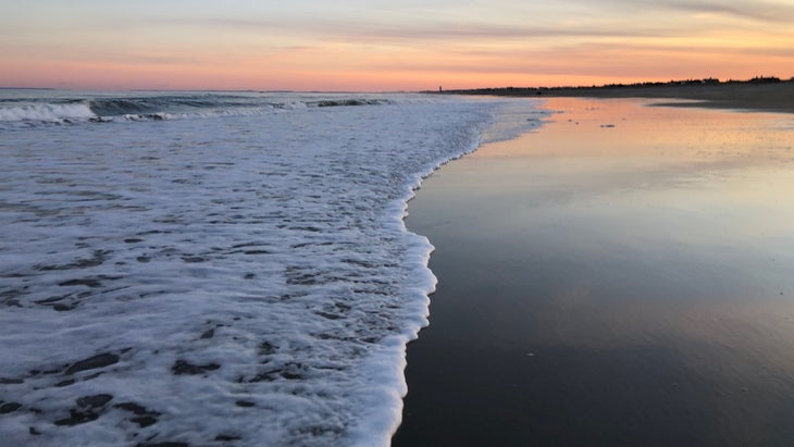 Walking the tidal line on Seabrook Beach in New Hampshire, one of the best east coast beaches for sunsets