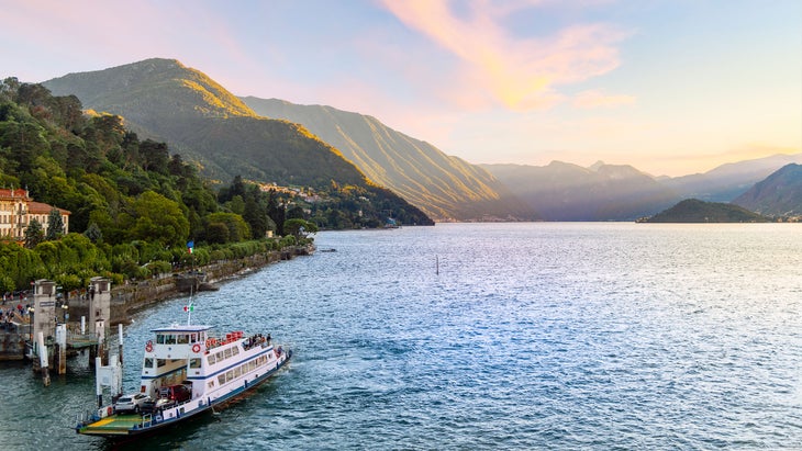 ferry boat in the town of Bellagio, Italy, as the sun sets on Lake Como