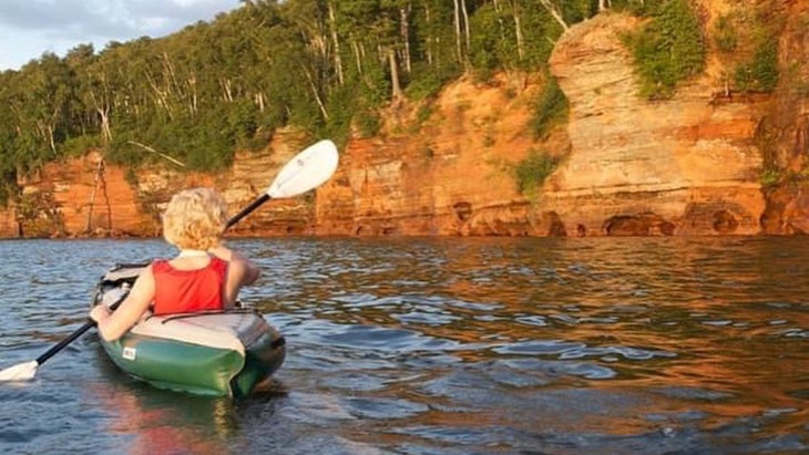 woman kayaks on Lake Superior