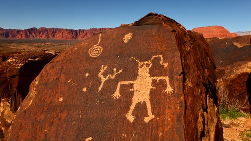A slab of red rock covered in petroglyphs is evidence of Native U.S. history.