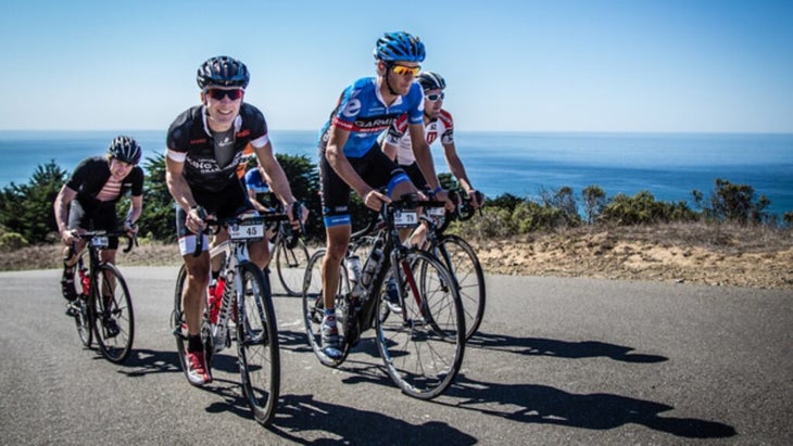 A group of riders follow pro cyclist Pete Stetina, wearing a blue kit and helmet, up a hill in Sonoma County. 