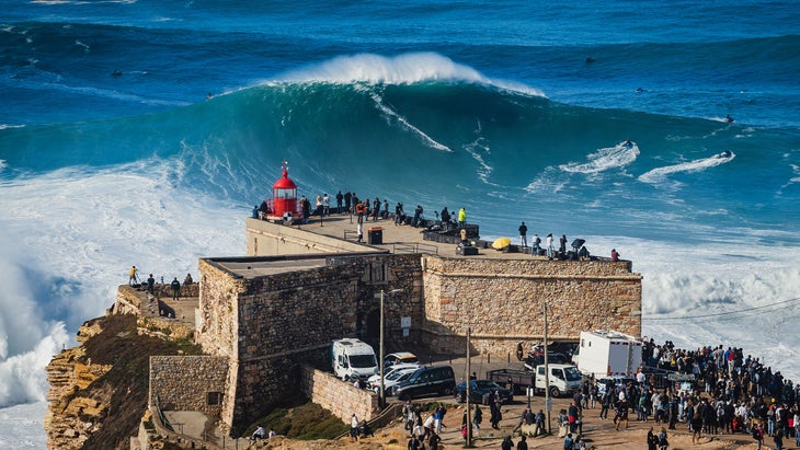 surfer riding a big wave in nazare portugal