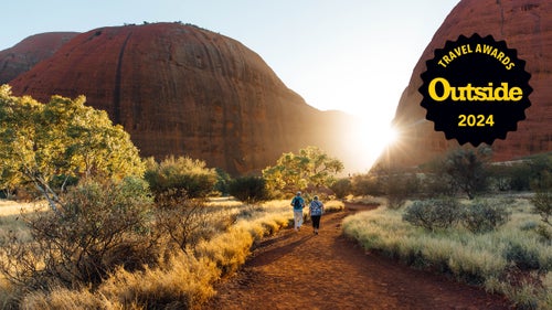Hikers amble through Valley of the Winds in Australia’s Uluru–Kata Tjuta National Park.