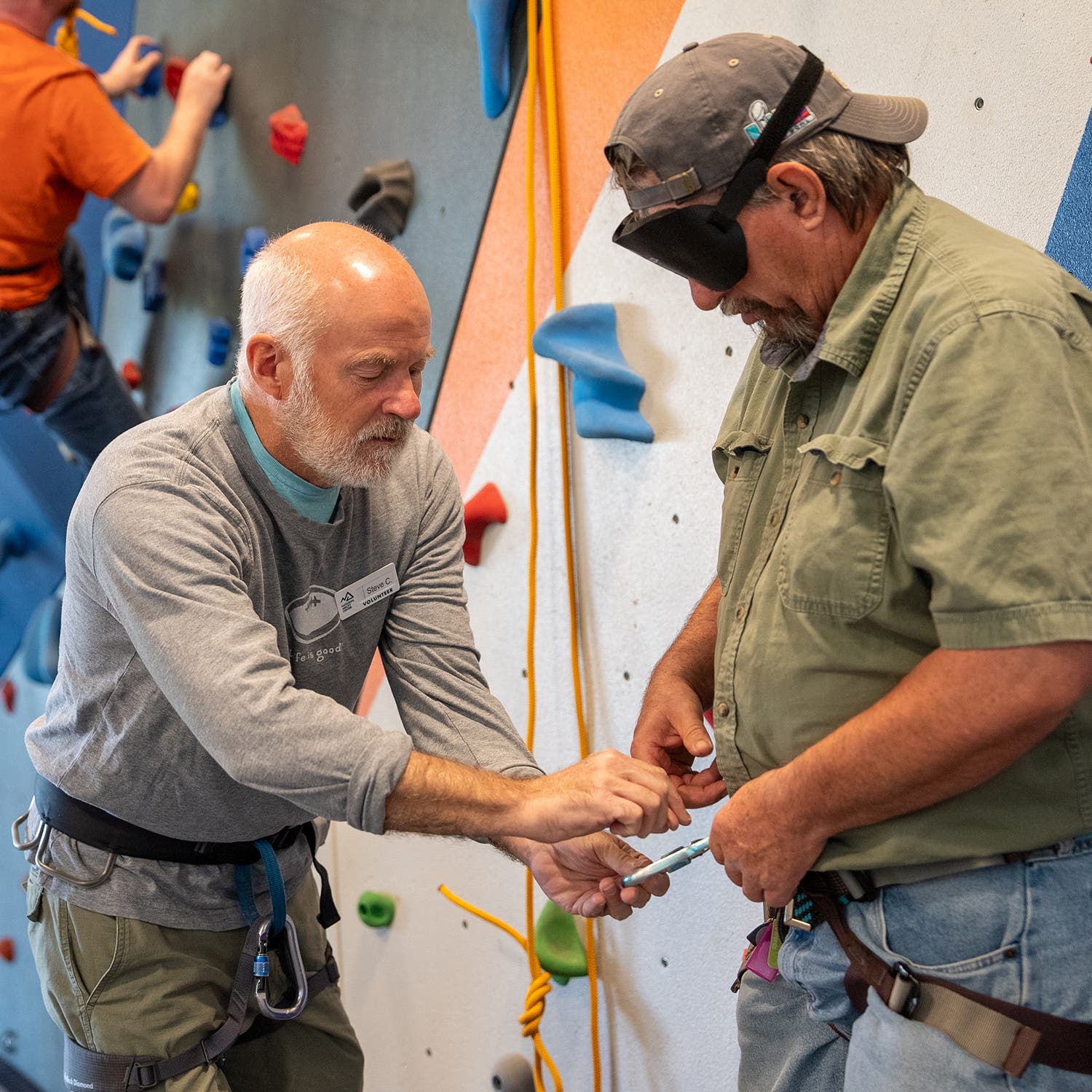 A blind man gets climb-ready at the National Ability Center in Park City, Utah.