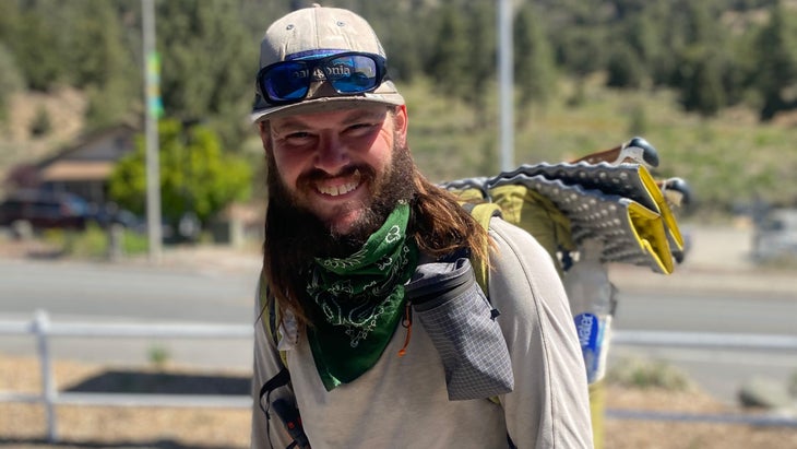 A hiker smiles into the camera.