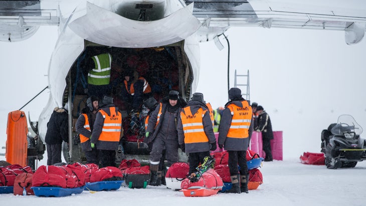 Workers unload a plane at Barneo Ice Camp. 