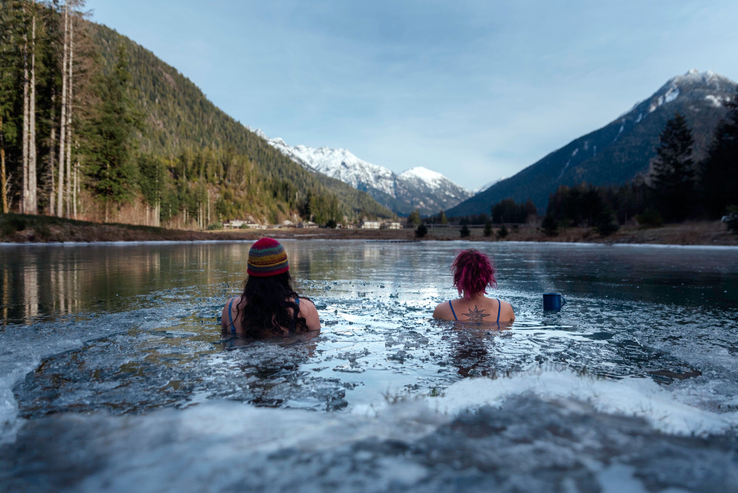 Cold plungers sit in the freshwater pond “The Oasis” looking out to the Bedwell Valley, which is home to the Clayoquot Wilderness Lodge. (Photo: Yasmin Käppeler)  