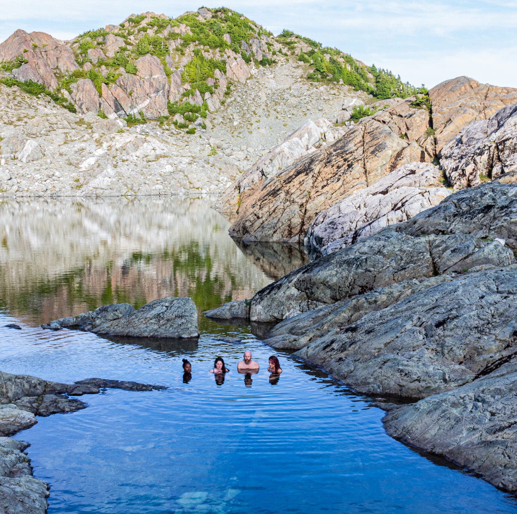 Cold plungers sit in a glacial lake at Clayoquot Wilderness Lodge. 