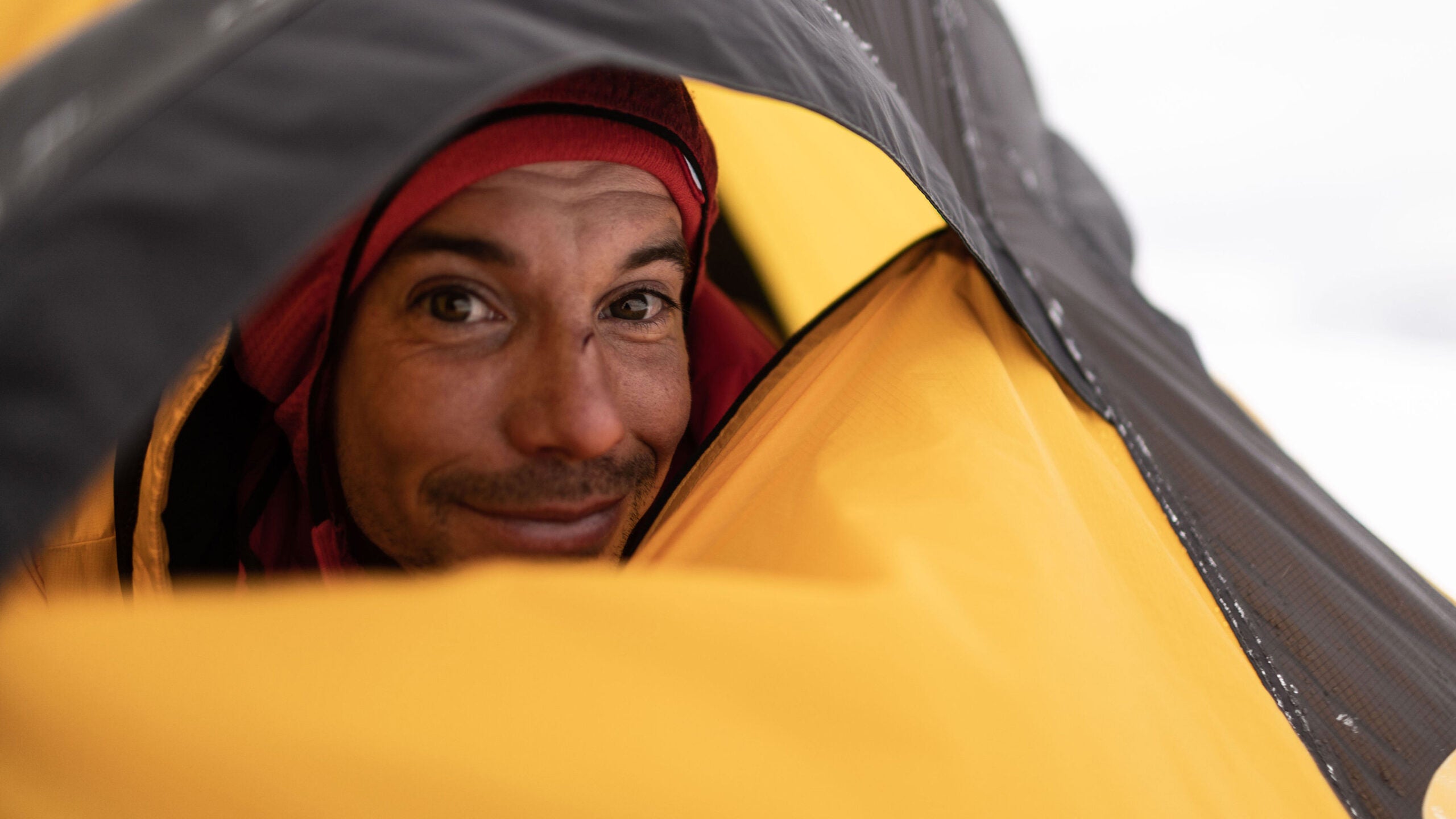 Rock climber Alex Honnold looks out of his tent.