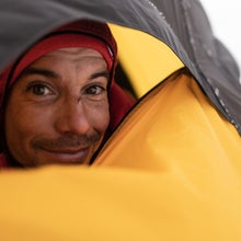 Rock climber Alex Honnold looks out of his tent.