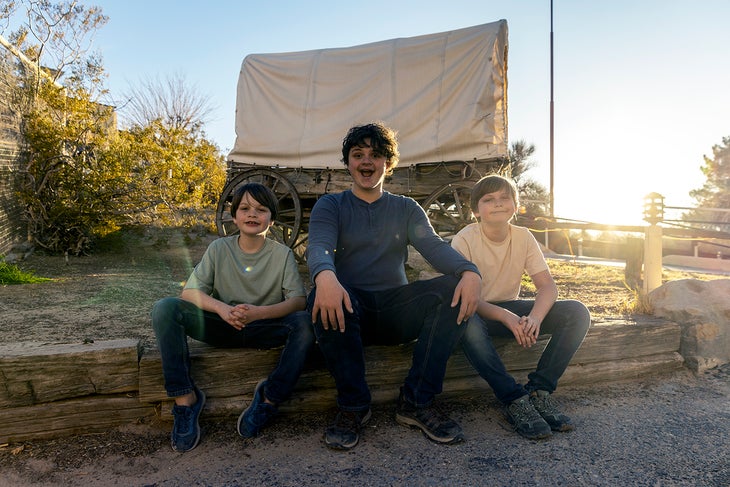 Three kids exploring the Western film set at Indian Cliffs Ranch