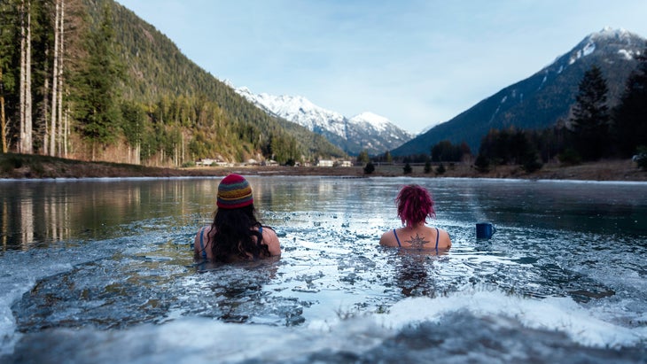 Cold plungers sit in the freshwater pond “The Oasis” looking out to the Bedwell Valley, which is home to the Clayoquot Wilderness Lodge.
